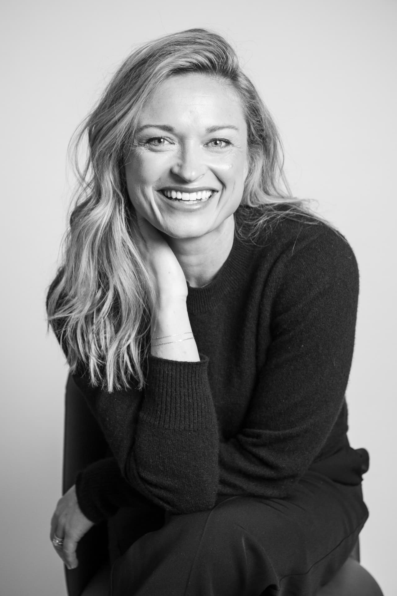 Black-and-white portrait of a smiling creative business owner